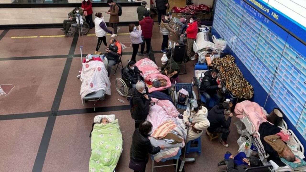 Patients lie on beds and stretchers in a hallway in the emergency department of a hospital, amid the coronavirus disease (Covid-19) outbreak in Shanghai, China January 4, 2023. Credit: Reuters Photo