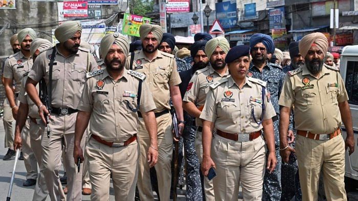 Police and security personnel patrol in the village Jallupur Khera about 45 km from Amritsar on March 19, 2023. - A manhunt for a radical Sikh preacher in India entered its second day on March 19, after authorities shut mobile internet in the whole of Punjab state and arrested 78 of his supporters. Credit: PTI Photo