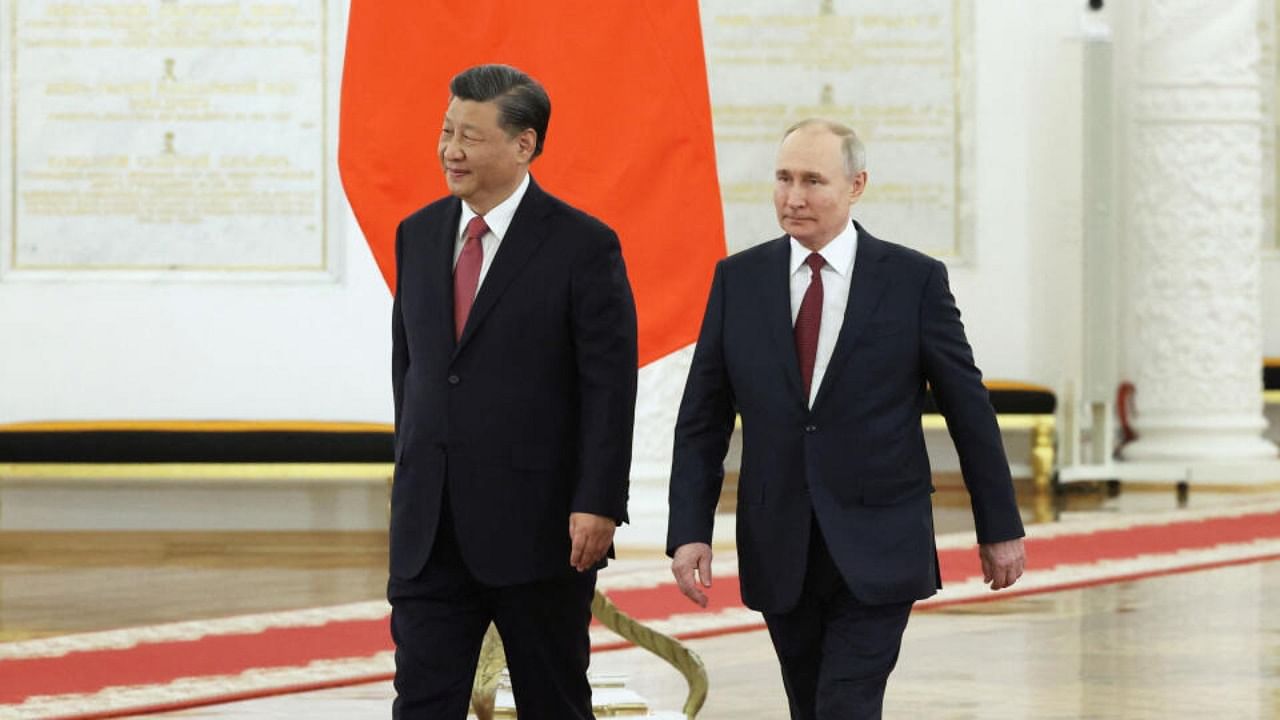 Russian President Vladimir Putin and Chinese President Xi Jinping attend a welcome ceremony before Russia - China talks in narrow format at the Kremlin in Moscow, Russia March 21, 2023. Credit: Sputnik/Sergei Karpukhin/Pool via Reuters