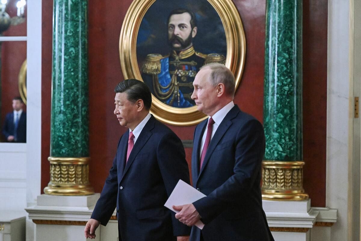 Russian President Vladimir Putin, right, and Chinese President Xi Jinping arrive to attend a signing ceremony following their talks at The Grand Kremlin Palace, in Moscow, Russia, Tuesday, March 21, 2023. Credit: AP/PTI