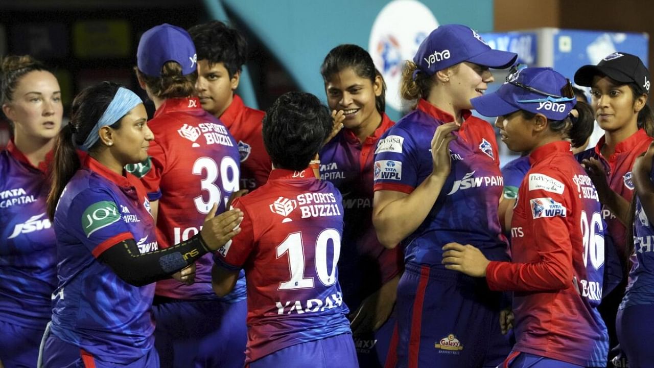 Delhi Capitals' celebrate after winning their Women's Premier League (WPL) cricket match against UP Warriorz, in Mumba. Credit: PTI Photo