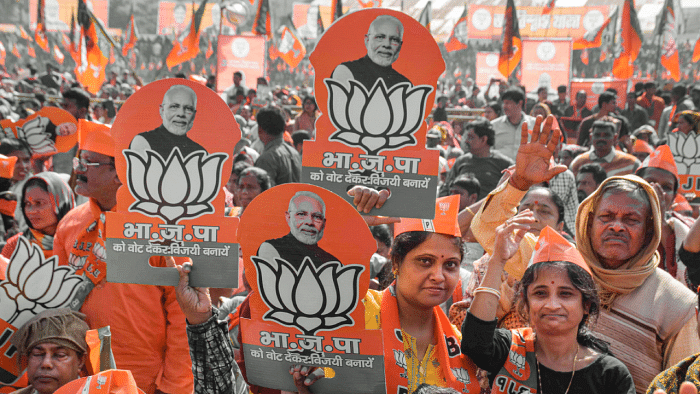 BJP supporters during the launch of the party's 'Jan Vishwas Yatra' by Amit Shah at Dhamanagar in poll-bound Tripura. Credit: PTI Photo