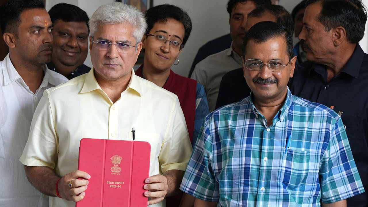 Delhi Chief Minister Arvind Kejriwal and Delhi Finance Minister Kailash Gahlot arrive for the presentation of Delhi Budget for the financial year 2023-24. Credit: PTI Photo