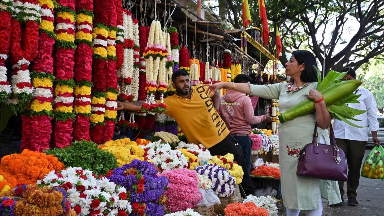 Customer buys flowers for Ugadi. Credit: AFP Photo