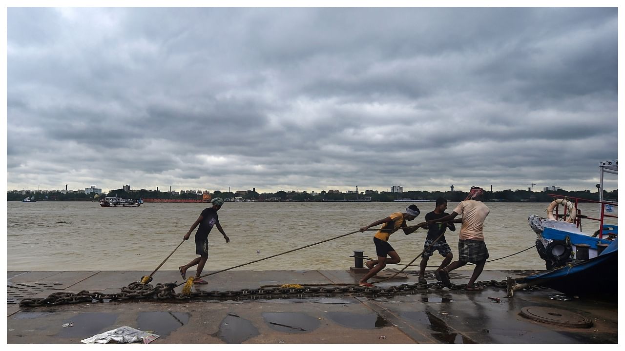 Workers anchor a ferry on the bank of the Ganga river. Credit: PTI Photo