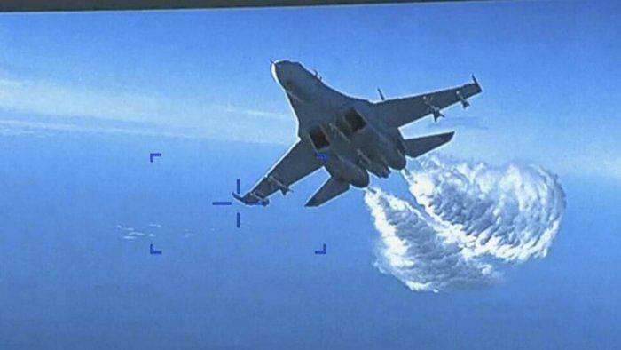 This photo taken from video released on Thursday, March 16, 2023, shows a Russian Su-27 approaching the back of the MQ-9 drone and beginning to release fuel as it passes, over the Black Sea, the Pentagon said. Credit: AP/PTI Photo