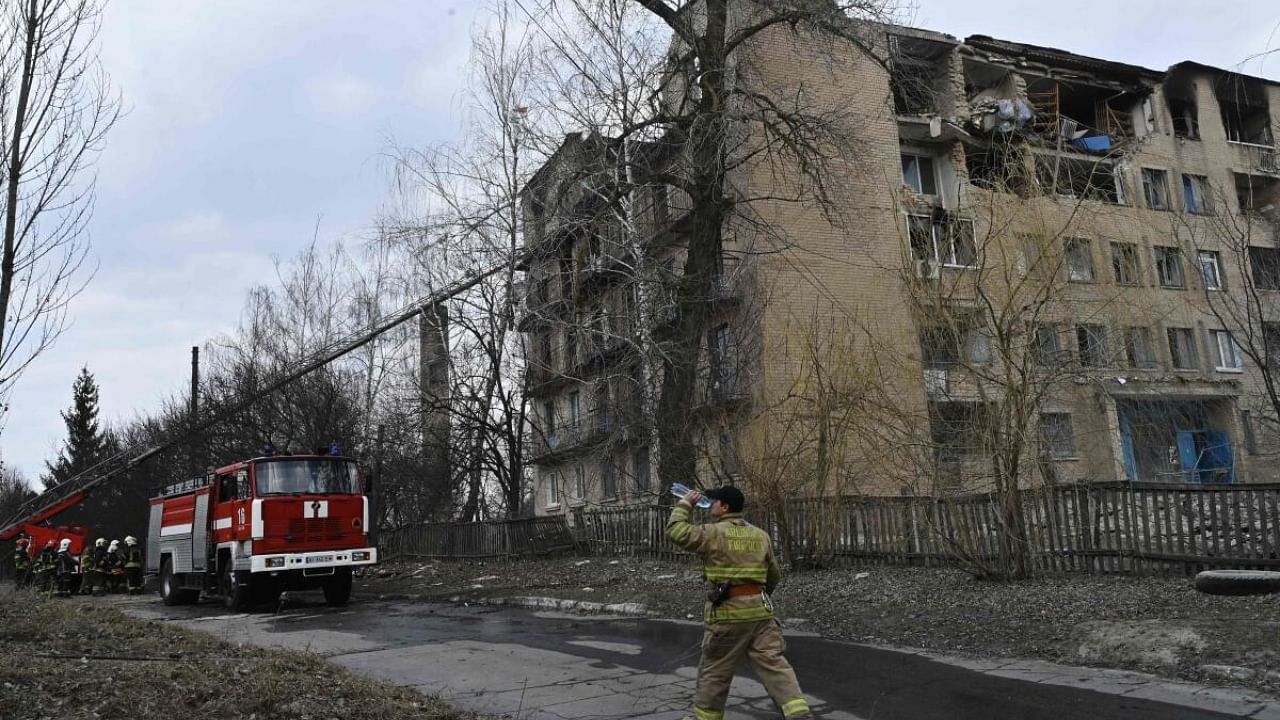 Rescuers work at a partially destroyed building after an air strike in the town of Rzhyshchiv, in the Kyiv region on March 22, 2023, amid the Russian invasion of Ukraine. Credit: AFP Photo