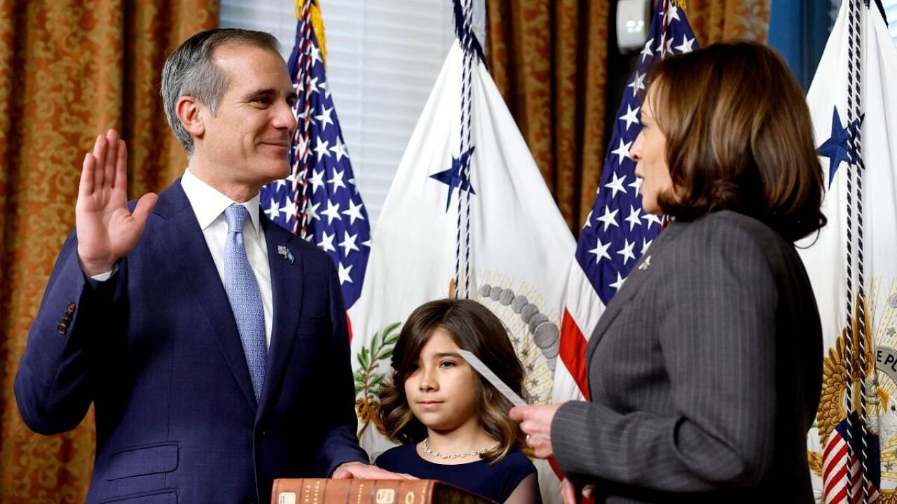 US Vice President Kamala Harris ceremonially swears in Eric Garcetti as Ambassador to India alongside his daughter Maya Garcetti at the Eisenhower Executive Office Building. Credit: Getty Images via AFP