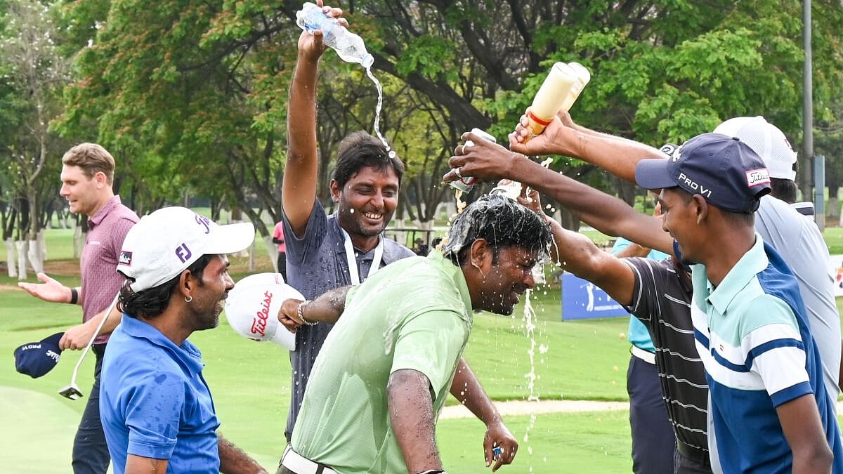 Om Prakash Chouhan (centre) is swamped by well-wishers after returning triumphant in the Duncan Taylor Black Bull Challenge 2023 at the KGA in Bengaluru on Sunday. Credit: DH Photo/ B H Shivakumar