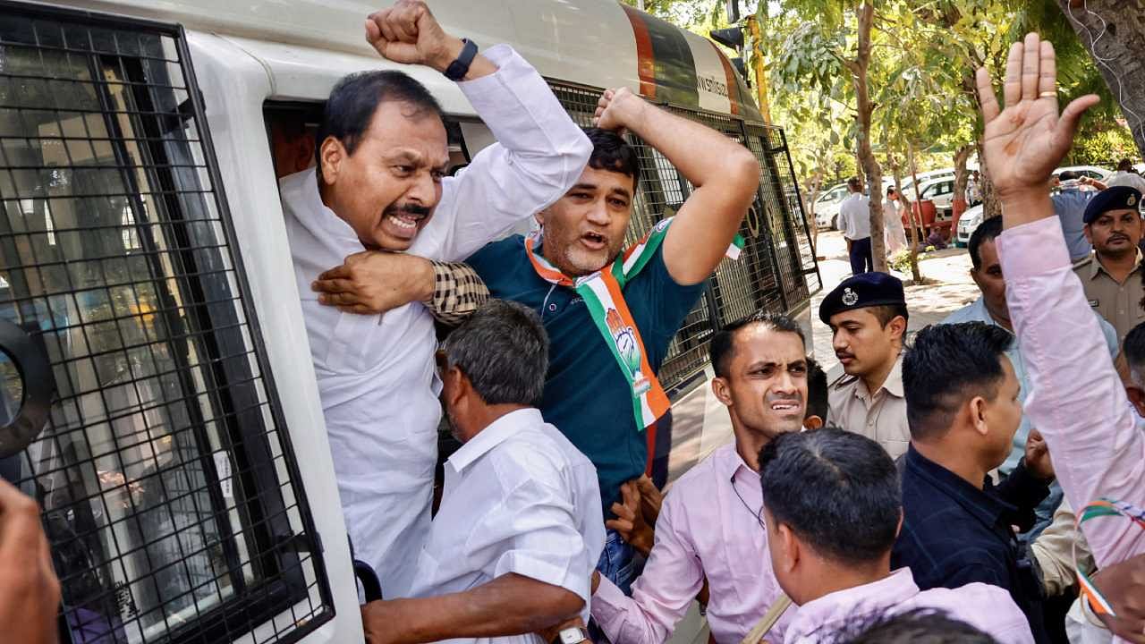 Congress supporters being detained by police during a protest against disqualification of Congress leader Rahul Gandhi from Lok Sabha, in Ahmedabad. Credit: PTI Photo