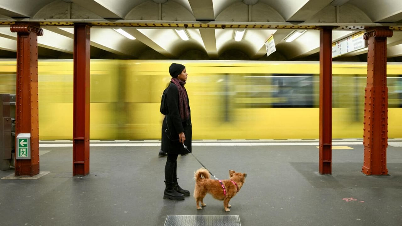 A commuter with a dog stands on a Berlin transport company BVG subway platform at Alexanderplatz station during a nationwide strike called by the German trade union Verdi over a wage dispute. Credit: Reuters Photo
