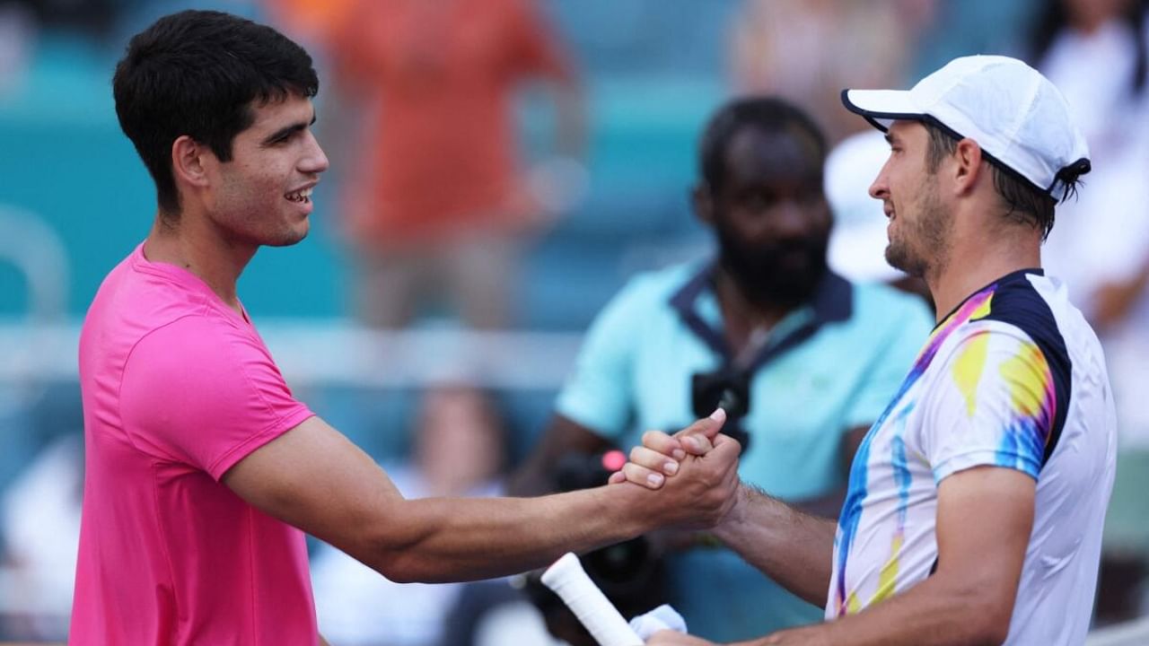 Carlos Alcaraz of Spain shakes hands at the net after his straight sets victory against Dusan Lajovic of Serbia in their third round match at Hard Rock Stadium on March 26, 2023 in Miami Gardens. Credit: AFP Photo