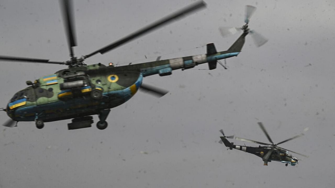 An Mi-24 (R) and an Mi-8 (L) helicopters take off for a mission against Russian targets in Ukraine. Credit: AFP Photo