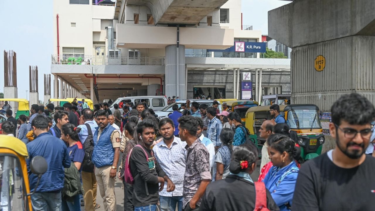 People wait endlessly for a bus outside the KR Pura metro station on Sunday. Lack of last-mile connectivity might impact commute to and from the stations. Credit: DH PHOTO/S K Dinesh