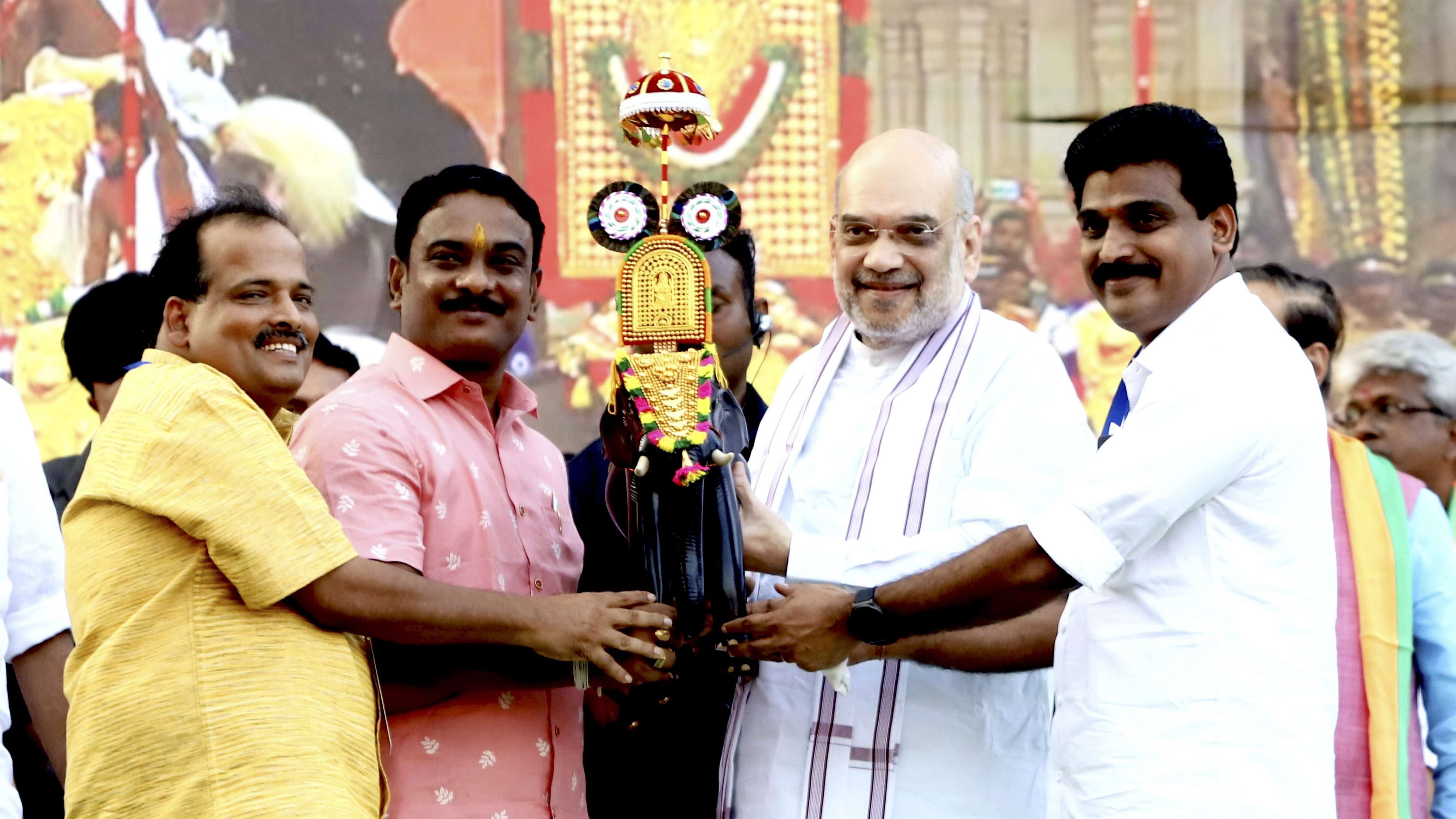  Union Home Minister Amit Shah being felicitated by BJP leaders during a public rally, in Thrissur, Sunday, March 12. Credit: PTI Photo