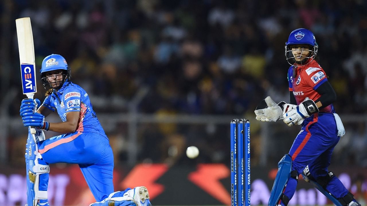 Mumbai Indians' captain Harmanpreet Kaur (L) plays a shot during the WPL final in Mumbai, March 26, 2023. Credit: AFP Photo