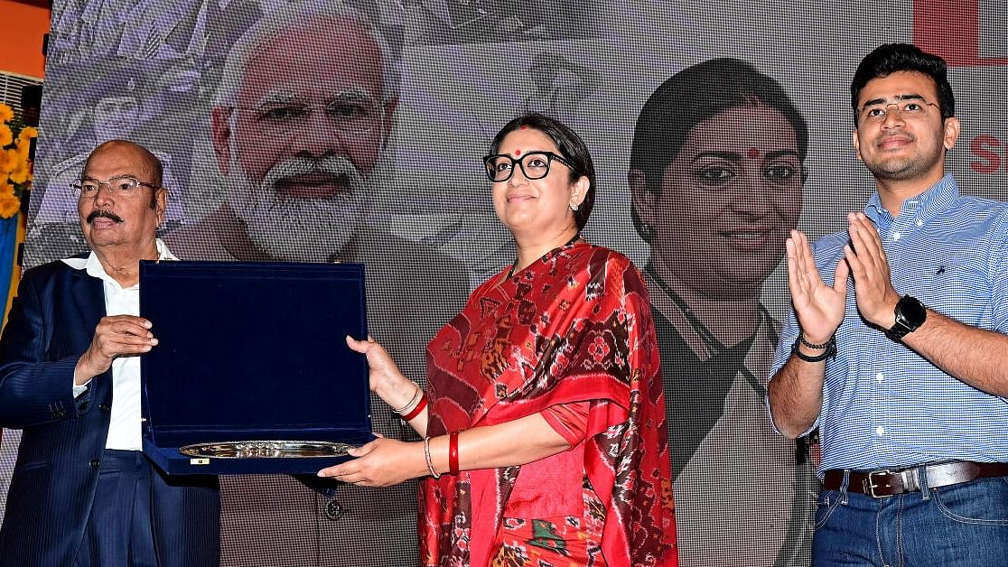 PES University vice chancellor Dr M R Doreswamy presents a memento to Union Minister Smriti Irani at the "Yuva Samvada - A Conversation with First Time Voters" organised by BJP Yuva Morcha, at the varsity in Bengaluru on Monday. Credit: Special Arrangement