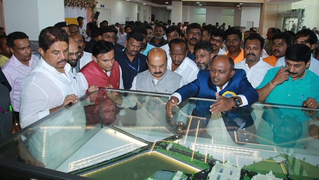 Chief Minister Basavaraj Bommai takes a look at the miniature replica of Nandi Medical College and Research Institute in Chikkaballapur on Monday. Credit: DH Photo