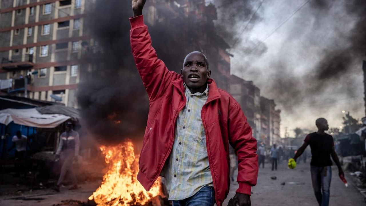 An opposition supporter holds a stone during clashes with Kenya Police Officers at the informal settlement of Mathare in Nairobi. Credit: AFP Photo