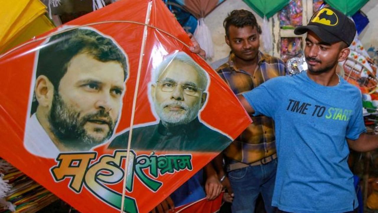  A shopkeeper displays colourful kites bearing photos of Prime Minister Narendra Modi and Congress leader Rahul Gandhi. Credit: PTI Photo