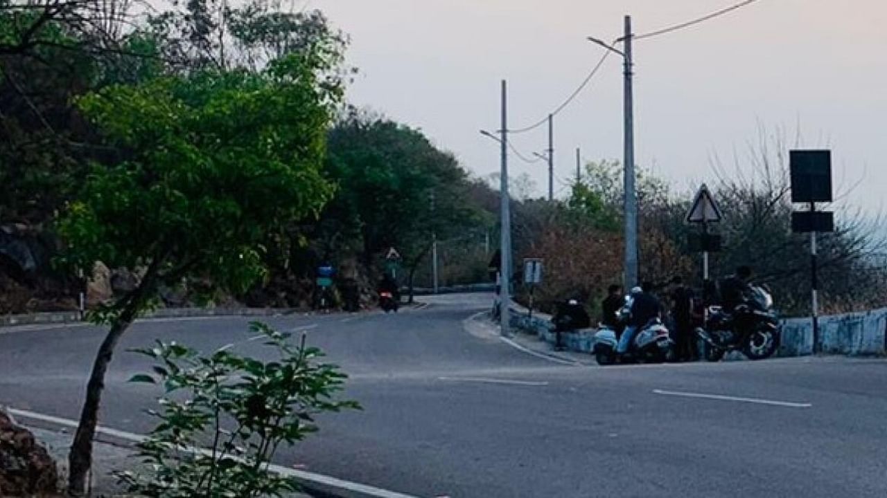 Youths with their vehicles, on Chamundi Hill Road, in Mysuru. Credit: Special Arrangement