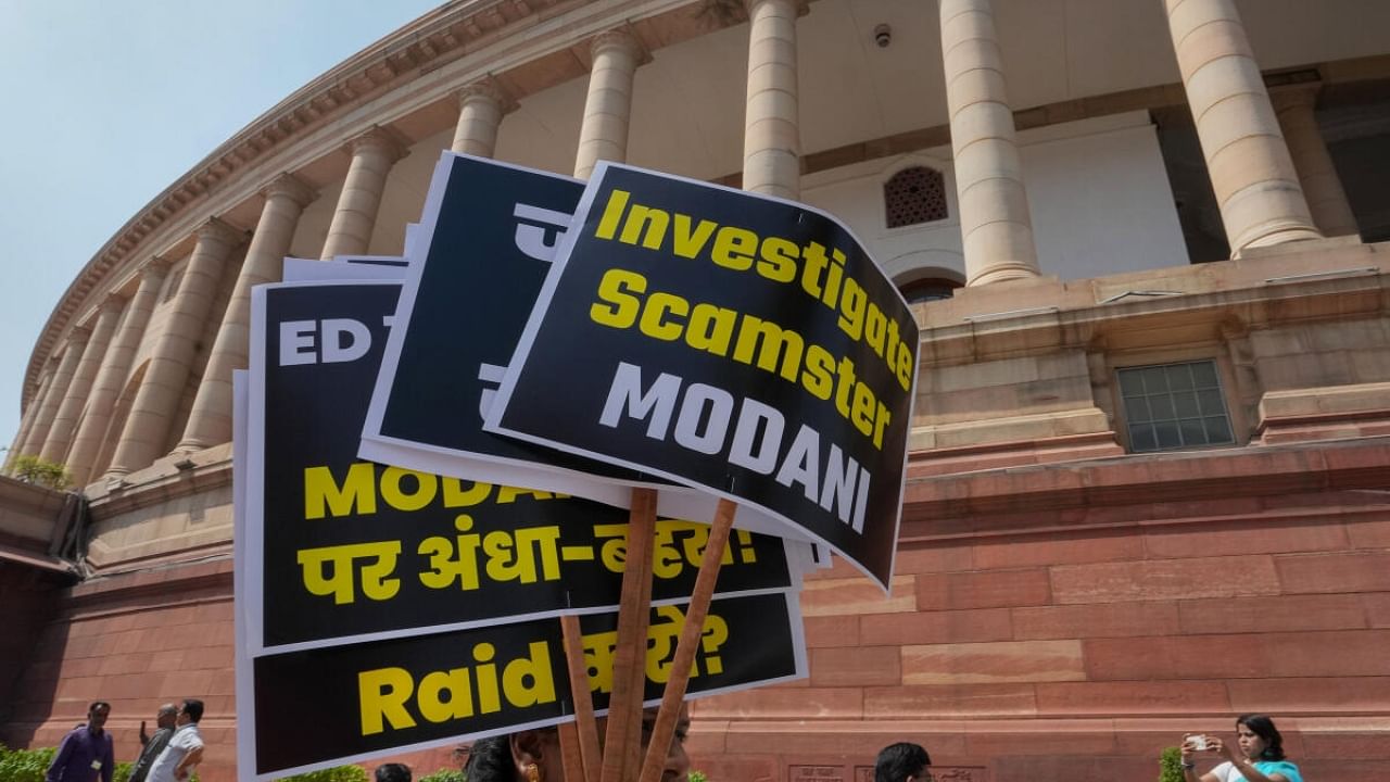 Placards used during a protest by Opposition MPs over the Adani Group issue at Parliament House complex during Budget Session. Credit: PTI Photo