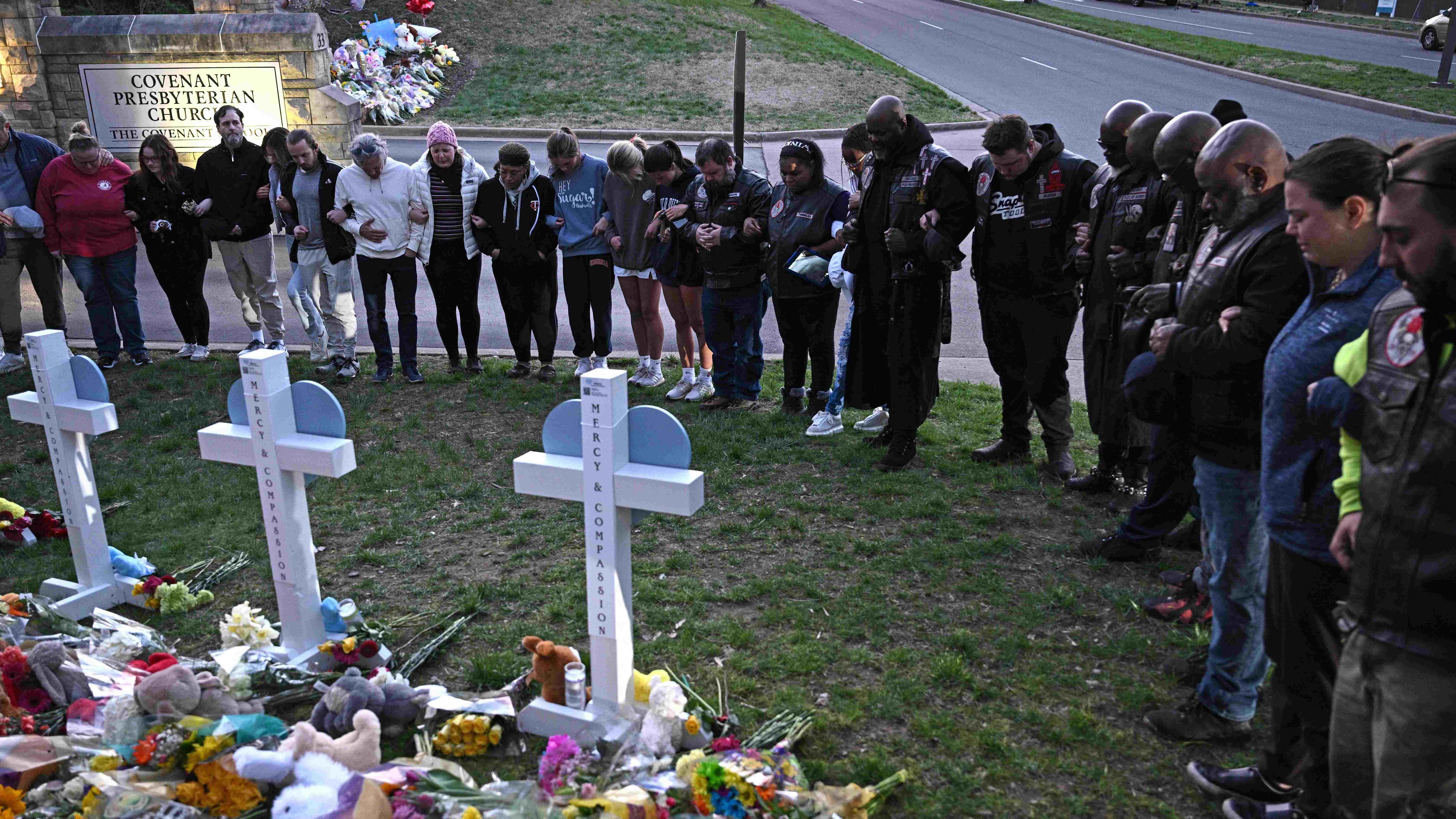 Members of the Selected First Motorcycle Club join others in prayer at a makeshift memorial for victims of a shooting at the Covenant School campus, in Nashville, Tennessee, March 28. Credit: AFP Photo