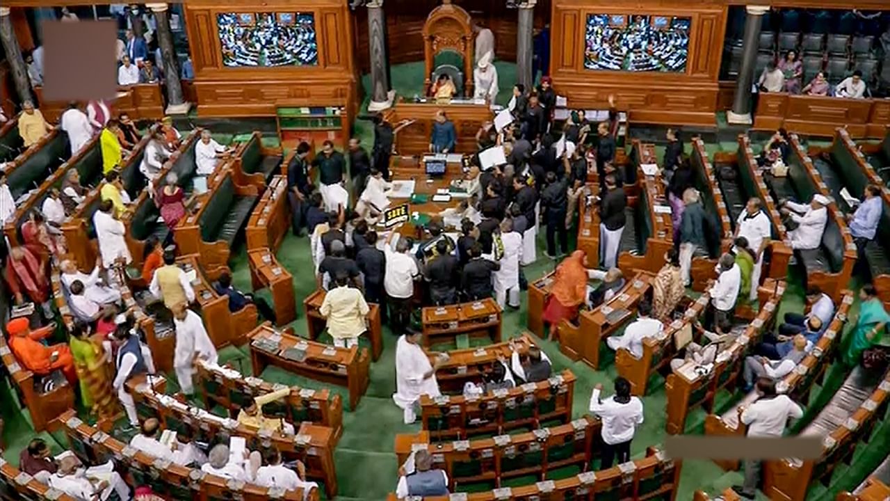 Opposition MPs, wearing black over the disqualification of Congress leader Rahul Gandhi from Lok Sabha, protest in the well of the House during Budget Session of Parliament, in New Delhi, Tuesday, March 28, 2023. Credit: PTI Photo