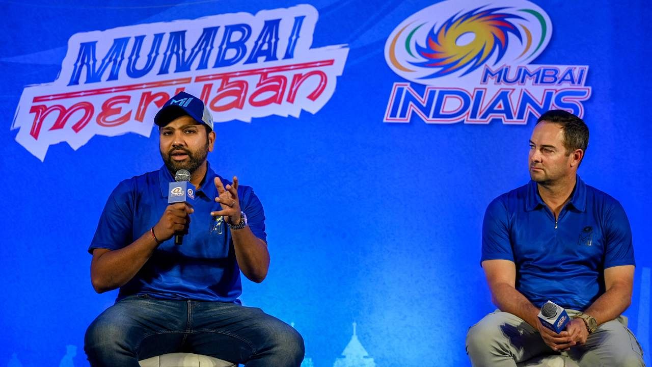 Mumbai Indians' cricket team captain Rohit Sharma speaks as coach Mark Boucher watches during a news conference in Mumbai. Credit: AFP Photo