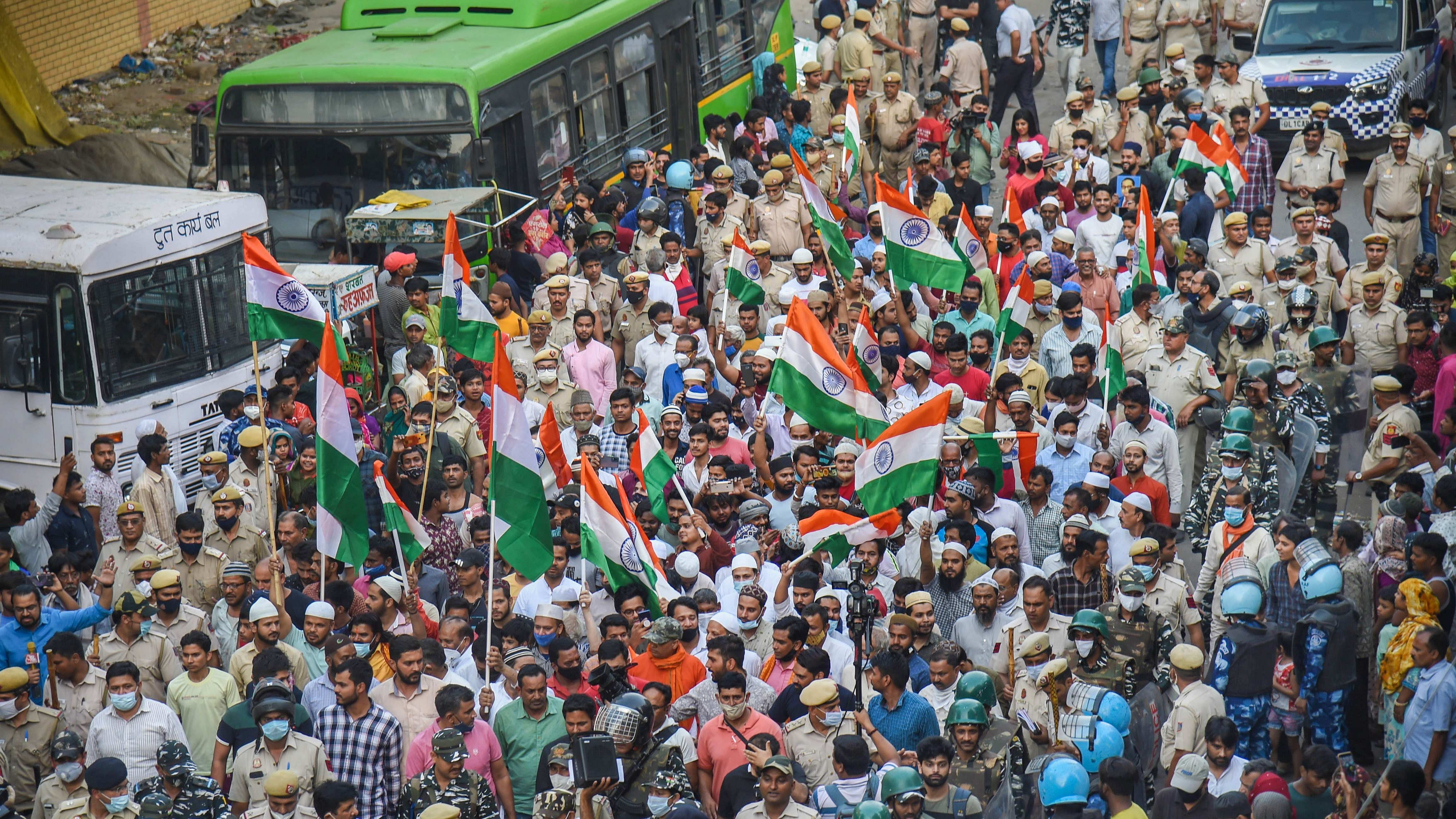 Members of both Hindu and Muslim communities take out a 'Tiranga Yatra' at the communal violence-hit Jahangirpuri area, in New Delhi, Sunday, April 24, 2022. Credit: PTI Photo