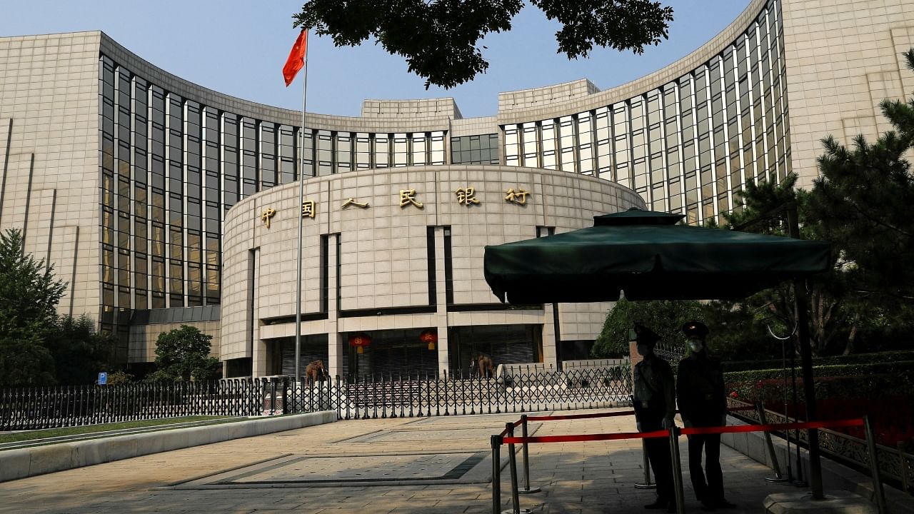 Paramilitary police officers stand guard in front of the headquarters of the People's Bank of China (PBOC), in Beijing, China, September 30, 2022. Credit: Reuters File Photo