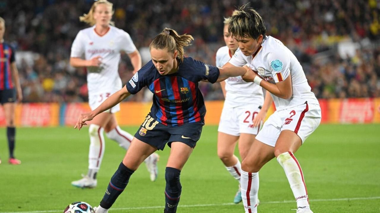 Barcelona's Norwegian forward Caroline Graham (L) vies with AS Roma's Japanese defender Moeka Minami during the UEFA Women's Champions League quarter-final. Credit: AFP Photo