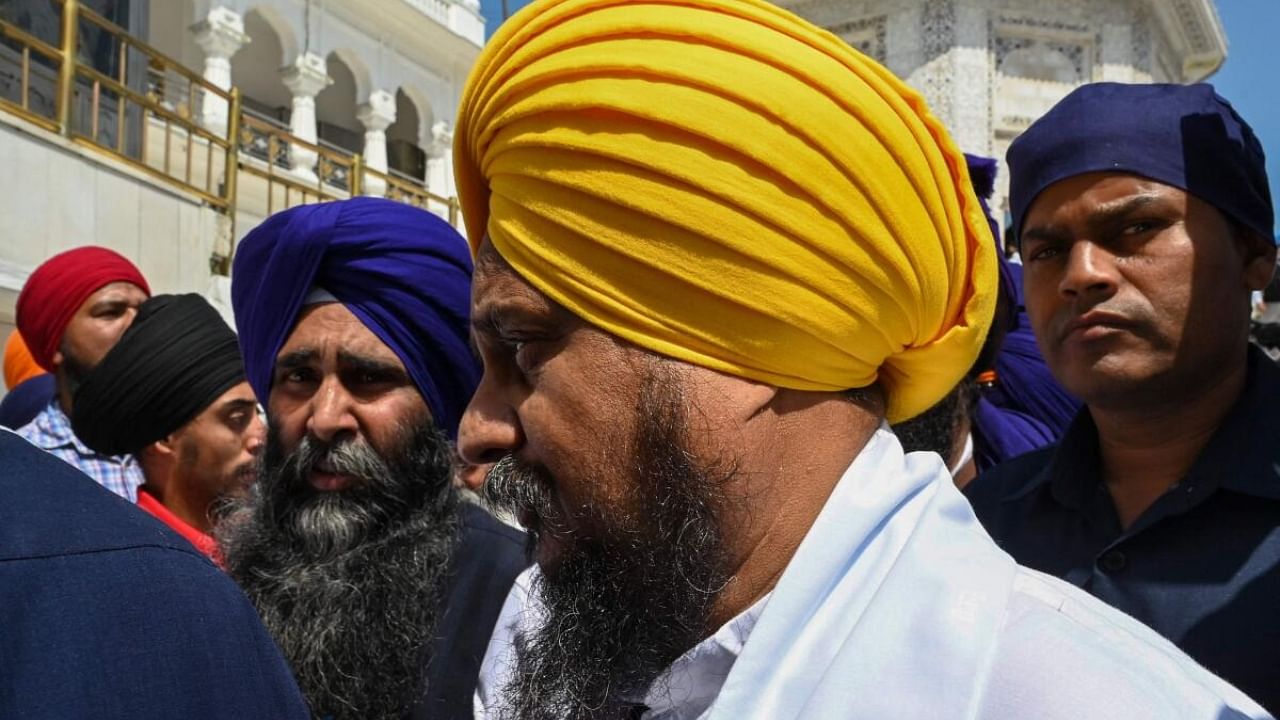 Jathedar (head priest) of the Akal Takht (seat of authority for Sikhs) Giani Harpreet Singh (C) arrives to attend a special meeting on India's Punjab state's prevailing situation, at the Golden Temple in Amritsar. Credit: AFP Photo