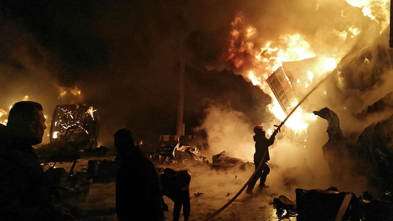 File photo of firefighters battling a blaze at Syria's Latakia port after an Israeli air strike. Credit: AFP Photo