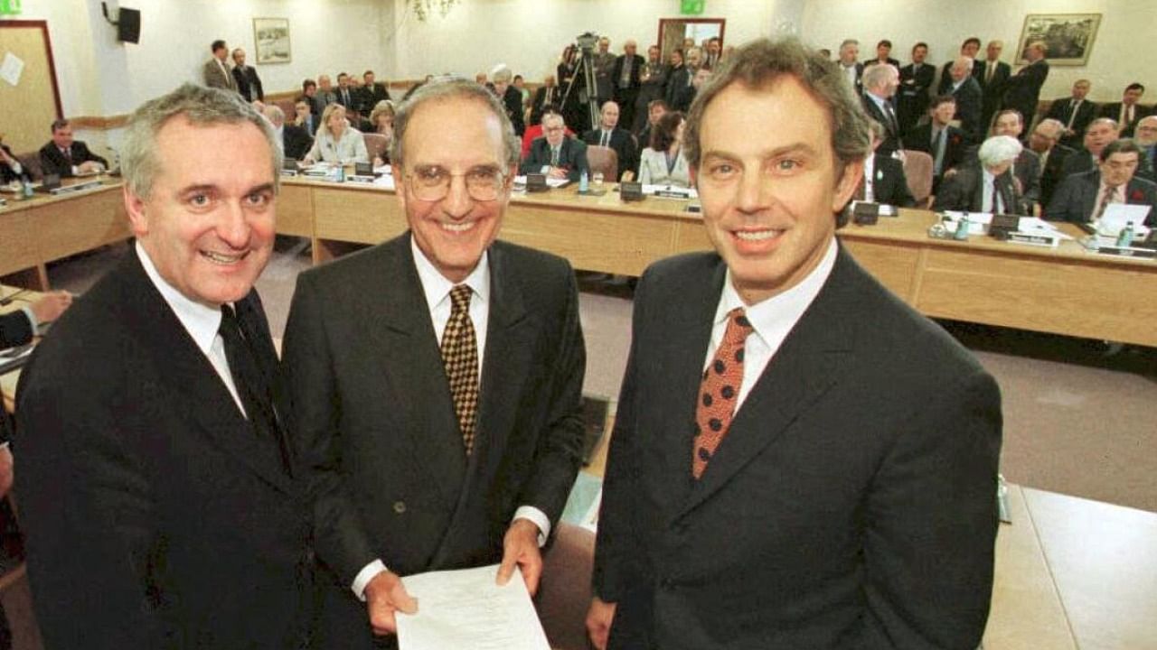 File photo from 1998 with then British PM Tony Blair (R), US Senator George Mitchell (C) and Irish PM Bertie Ahern pose for a photograph after signing an historic agreement -- The Good Friday Agreement. Credit: AFP