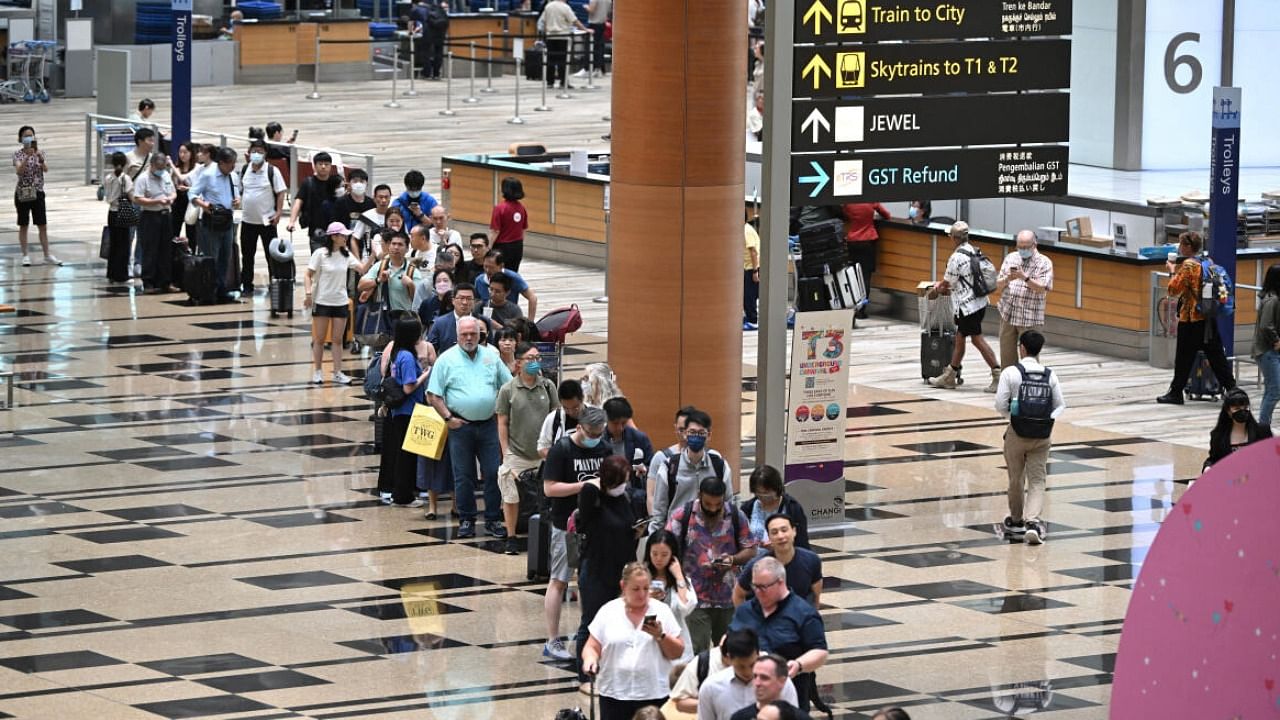 Passengers queue at the departure hall of Changi Airport Terminal 3 in Singapore. Credit: Reuters Photo