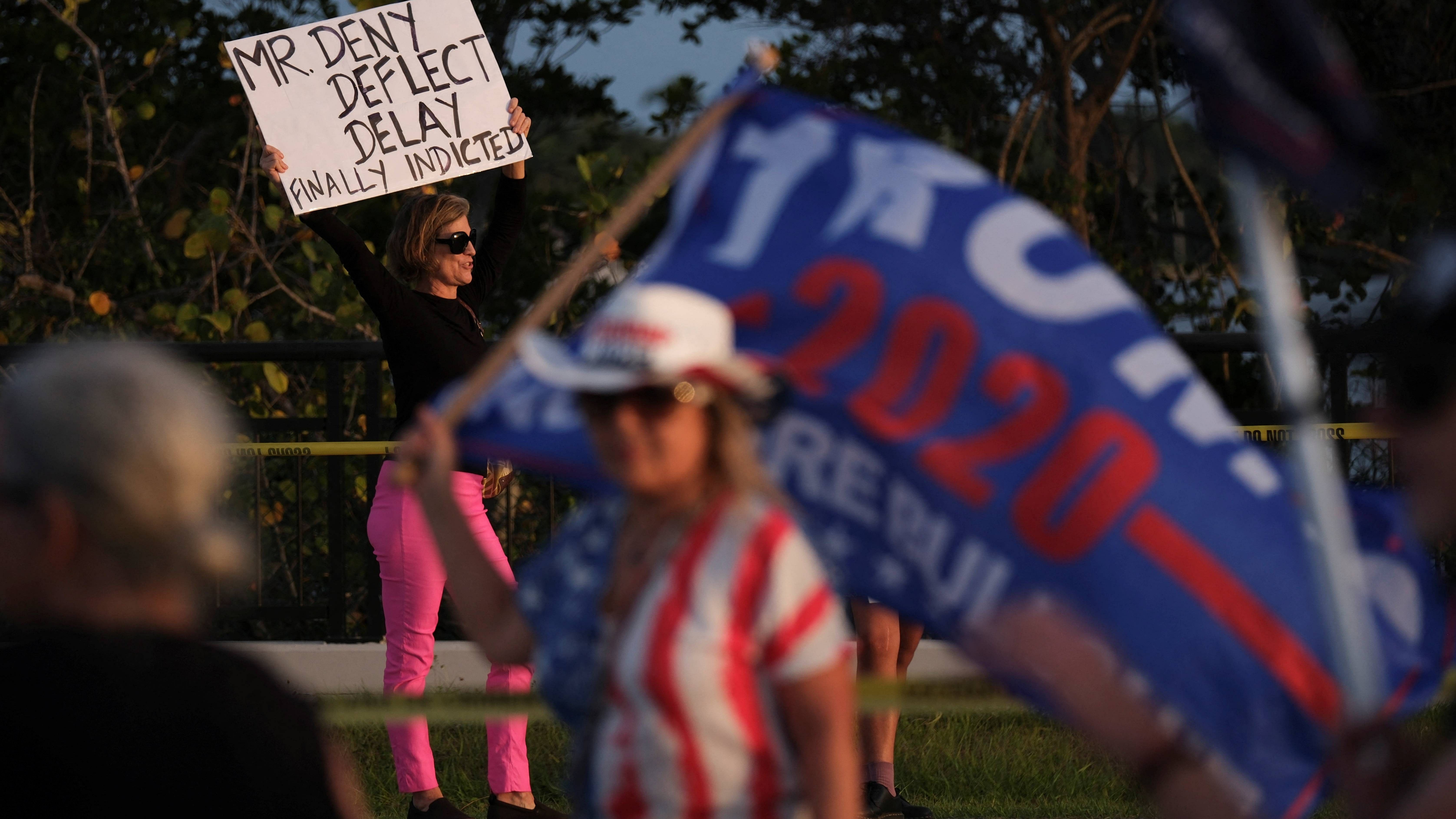 Anti-Trump protesters demonstrate across the street from Pro-Trump supporters outside the former U.S. President Donald Trump a day after he was indicted by a Manhattan grand jury following a probe into hush money paid to porn star Stormy Daniels, in Palm Beach, Florida, U.S. March 31, 2023. Credit: Reuters Photo