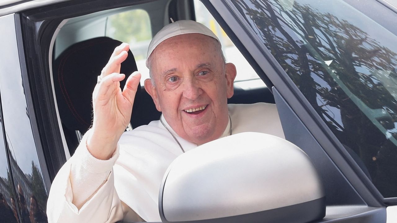 Pope Francis waves from a car as he leaves Rome's Gemelli hospital in Rome, Italy, April 1, 2023. Credit: Reuters Photo