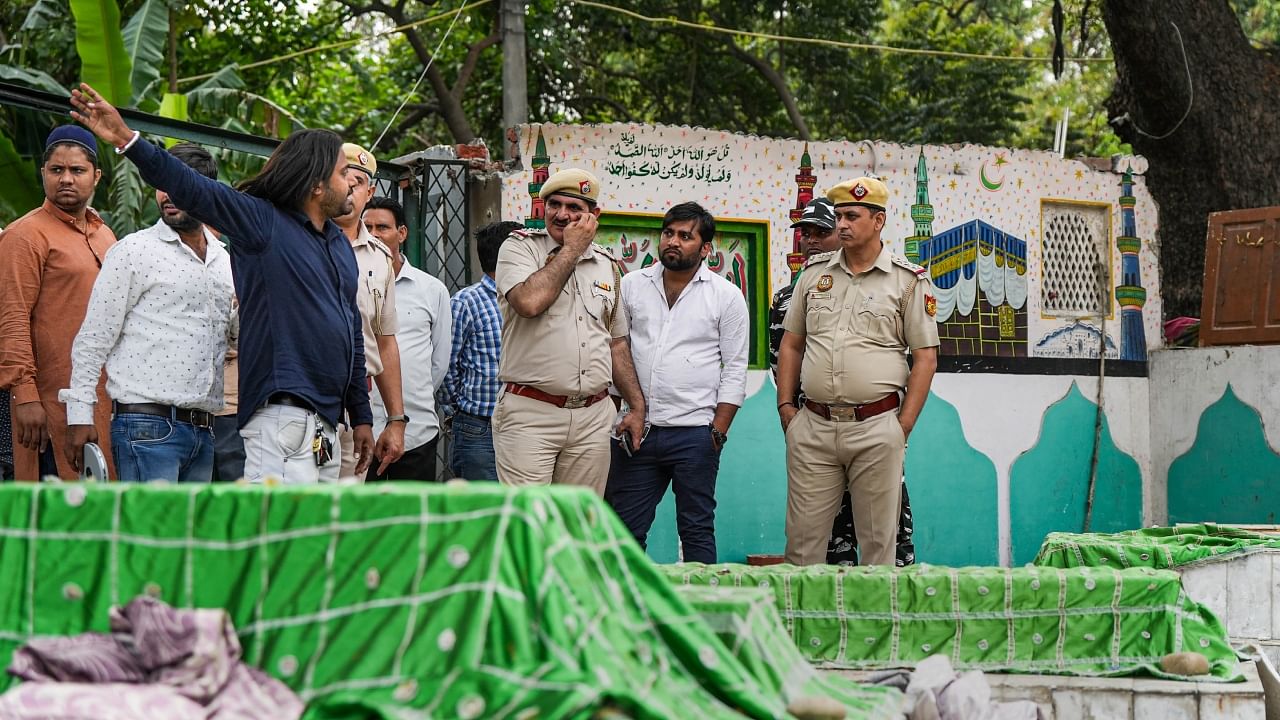 Police present during demolition work at the Bhure Shah dargah on the Zakir Hussain Marg, in New Delhi, Saturday, April 1, 2023. Credit: PTI Photo