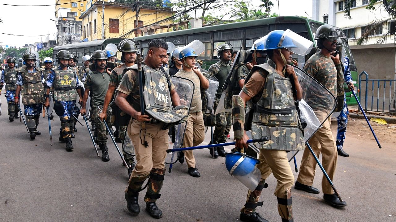Security personnel conduct a flag march after clashes broke out between two groups during a 'Ram Navami' procession on Thursday, at Kajipara in Howrah district, Friday, March 31, 2023. Credit: PTI Photo