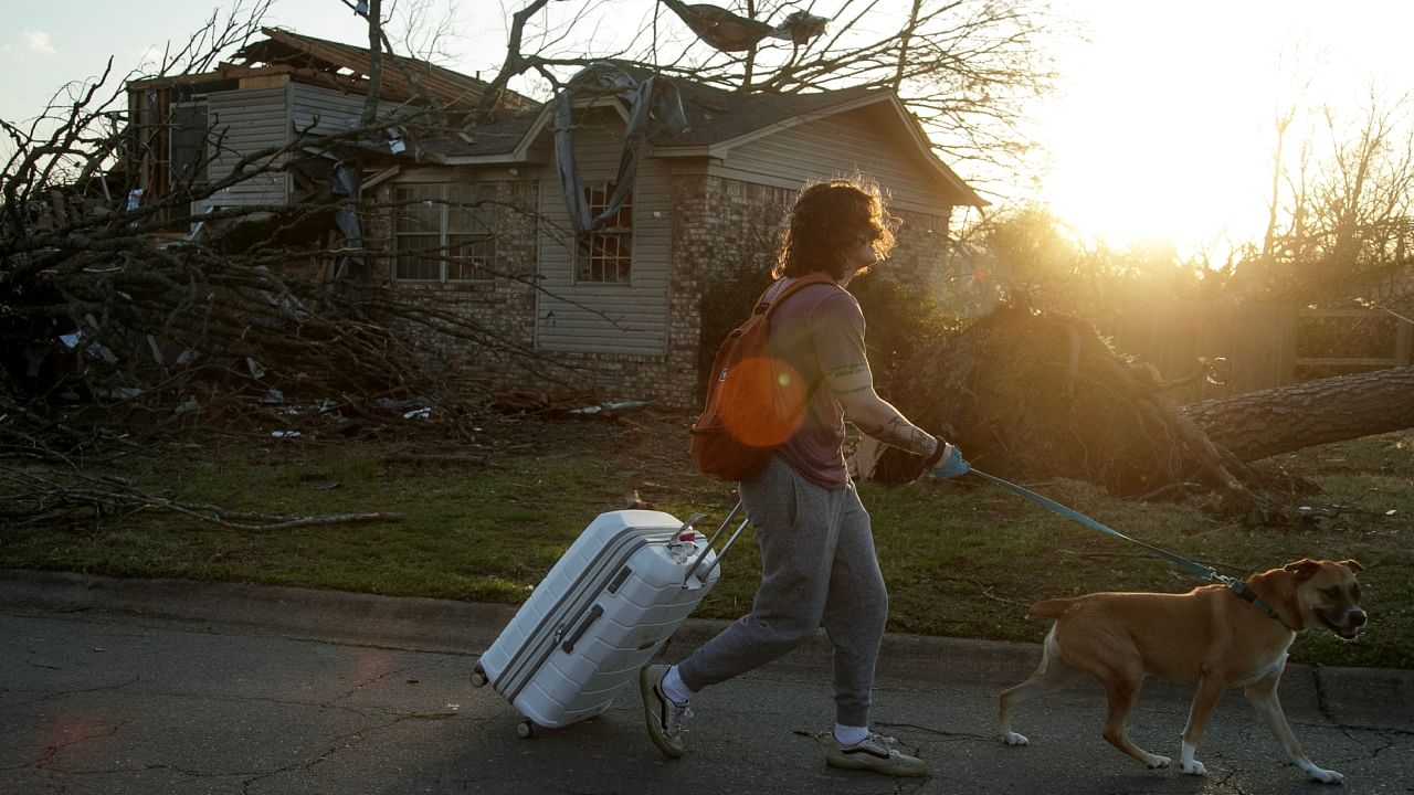 A resident evacuates their neighborhood after a large tornado damaged hundreds of homes and buildings on March 31, 2023 in Little Rock, Arkansas. Credit: Getty/AFP Photo