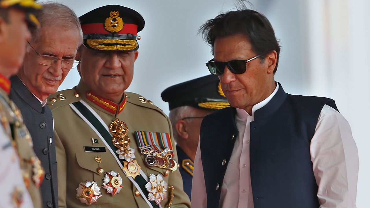 Former Pakistan Prime Minister Imran Khan, right, with former Army Chief General Qamar Javed Bajwa, center, March 2022. Credit: AP/PTI File Photo