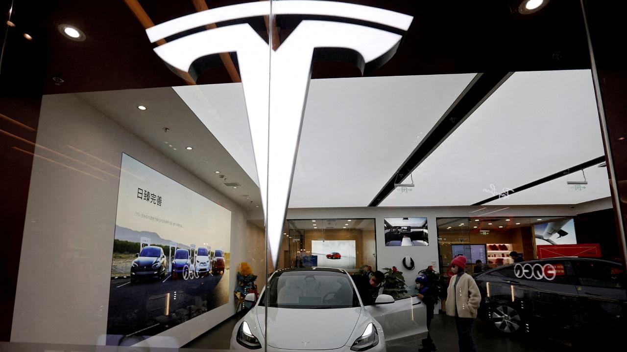 Visitors check a Tesla Model 3 car next to a Model Y displayed at a showroom of the US electric vehicle (EV) maker in Beijing, China February 4, 2023. Credit: Reuters File Photo