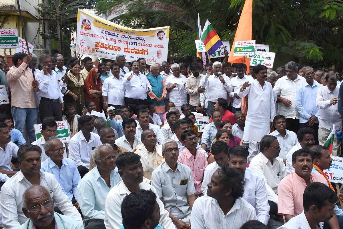Vishwakarms stage a protest in front of the deputy commissioner's office in Dharwad on Wednesday. Leaders Vasanth Arkachar, Mohan Arkasali and others are seen. Credit: DH Photo