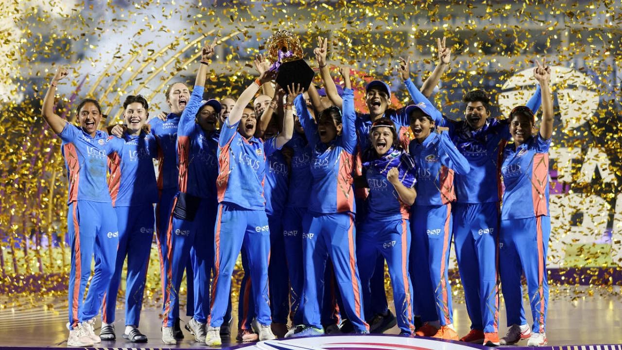 Mumbai Indians cricketers celebrate winning the maiden WPL tournament. Credit: Reuters Photo