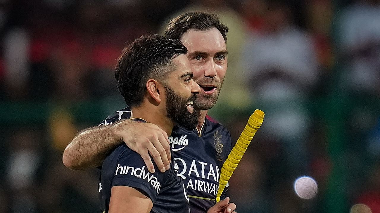 Royal Challengers Bangalore batters Virat Kohli and Glenn Maxwell walk back after winning over Mumbai Indians during the IPL 2023 match. Credit: PTI Photo