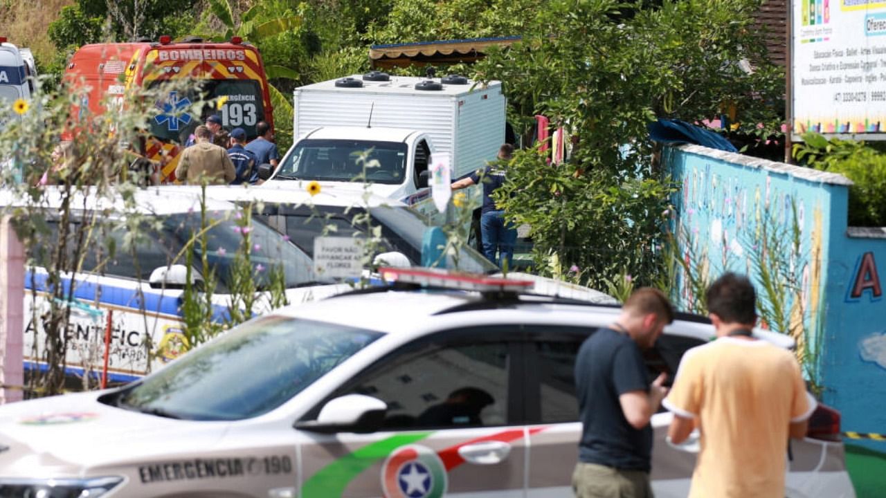A view shows forensic technicians, ambulances and policemen outside a pre-school after a 25-year-old man attacked children, killing several and injuring others, according to local police and hospital, in Blumenau, in the southern Brazilian state of Santa Catarina, Brazil April 5, 2023. Credit: Reuters Photo
