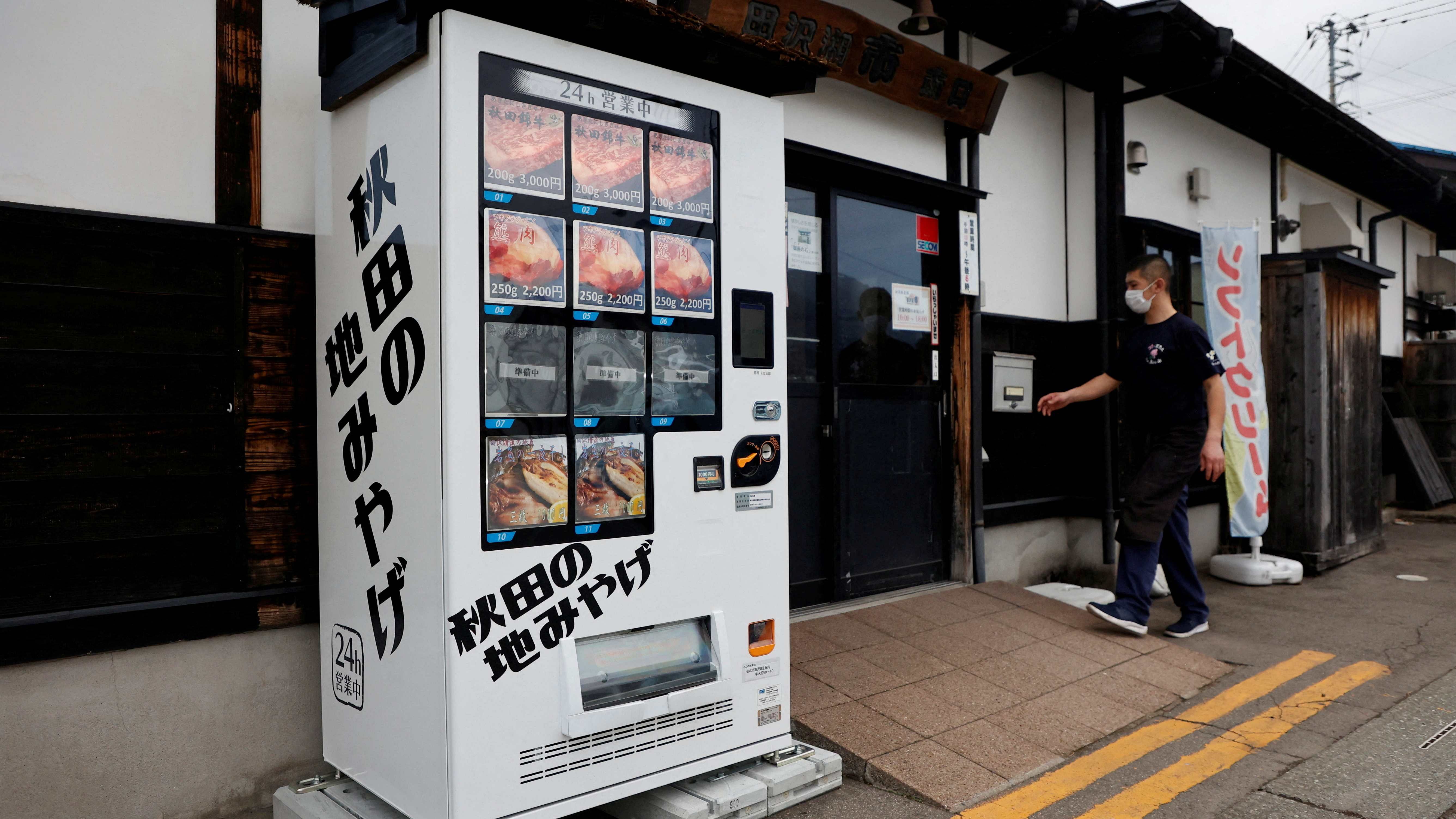 A vending machine menu offering Asian Black Bear meat, Akita Beef and dried mountain stream fish is seen in front of a Soba Noodle restaurant in Semboku. Credit: Reuters Photo