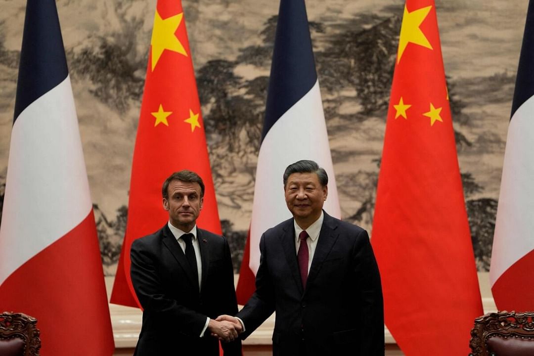 French President Emmanuel Macron (L) shakes hands with Chinese President Xi Jinping during a joint meeting of the press at the Great Hall of the People in Beijing. Credit: AFP Photo