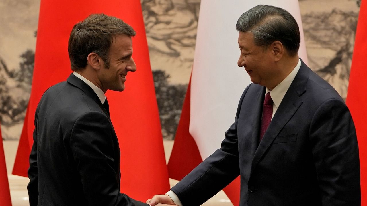 China’s President Xi Jinping (R) shakes hands with his French counterpart Emmanuel Macron after the signing ceremony in Beijing. Credit: AFP Photo